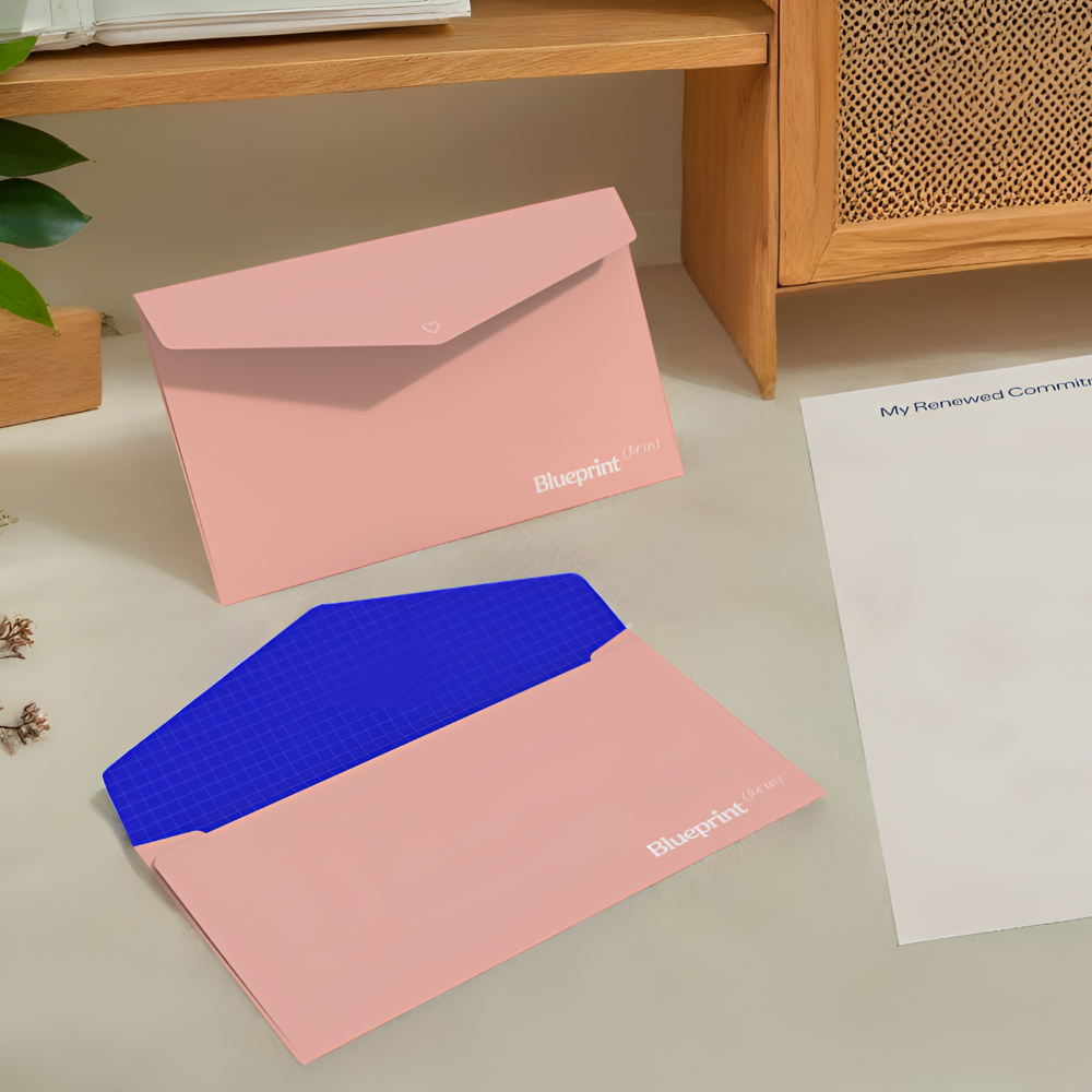 Pink and blue file folders with 'Blueprint' branding on a desk.