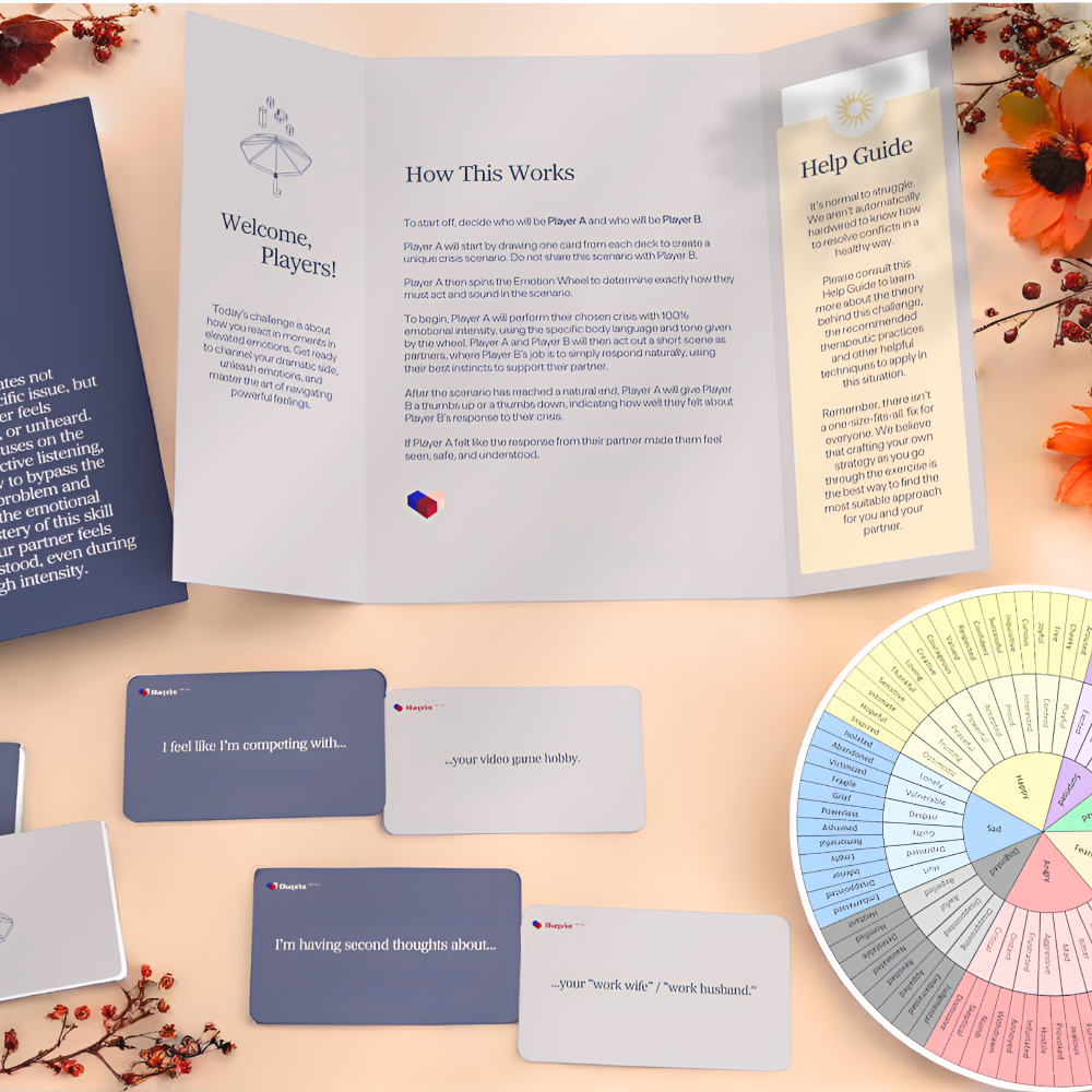 Card game components including a rulebook, cards, and a spinner on a wooden surface.